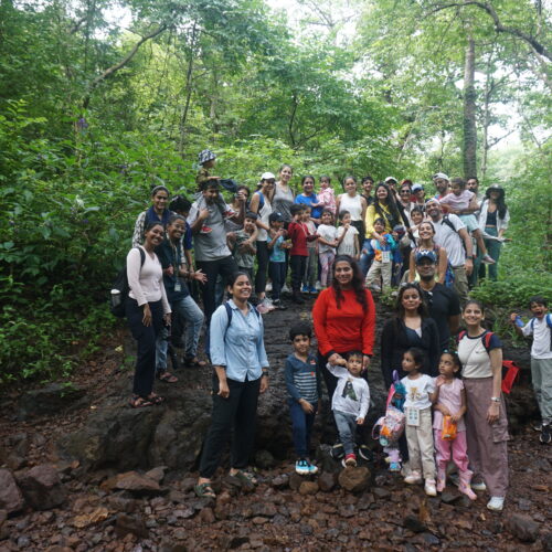 A huge group of kids and adults posing for a picture while on a nature trail, during monsoons at CEC BNHS