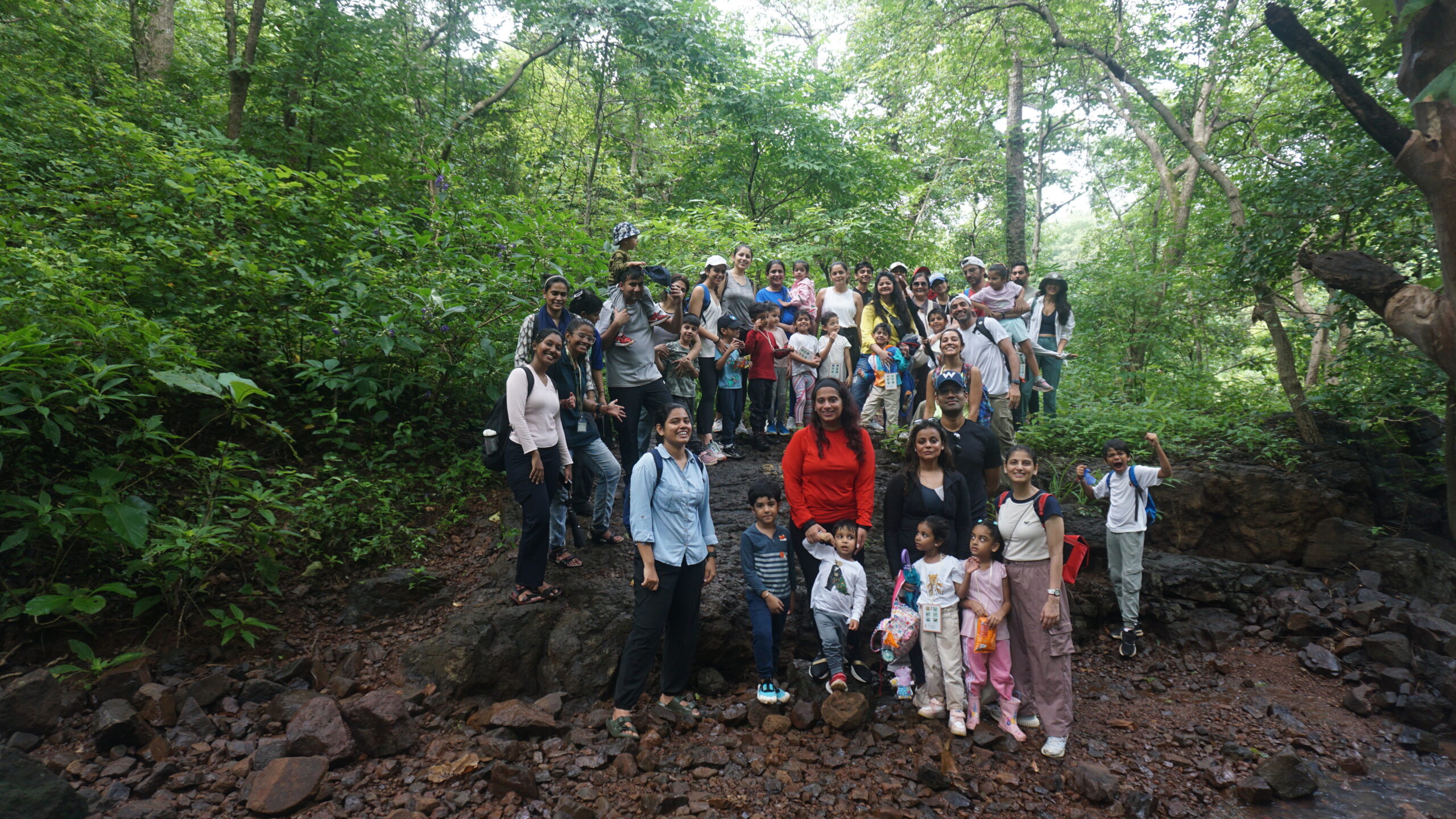 A huge group of kids and adults posing for a picture while on a nature trail, during monsoons at CEC BNHS